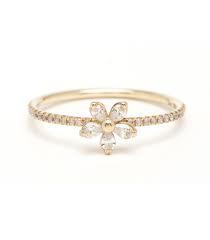very narrow gold band with diamonds and a 5-petal flower